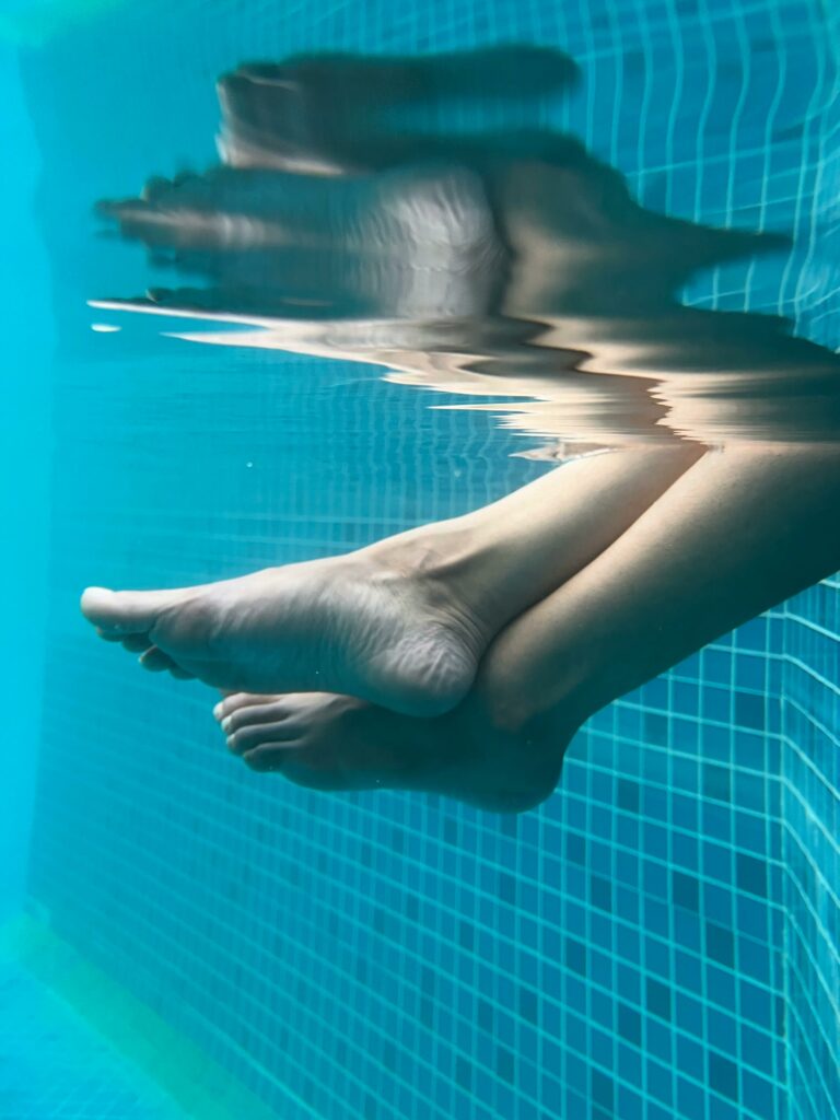pexels-photo-20781476-20781476 Close-up of feet underwater in a pool with clear reflections and relaxing vibe.